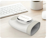 Thumbnail for White wireless hand and wrist massager with a rounded cuff and four-button control panel, on a desk beside a keyboard.