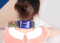 Thumbnail for Back view of a person wearing a blue translucent neck massager with black ends and 1-2-3 controls; pink blouse.