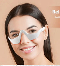 Thumbnail for Smiling woman wearing a white and gray curved EMS microcurrent eye care mask around her eyes.